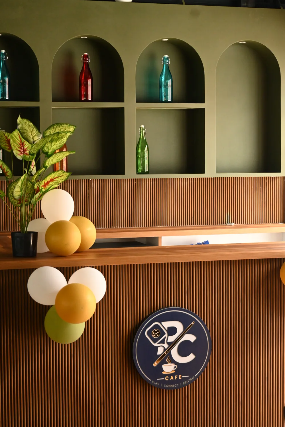 Café counter with decorative bottles and the club logo