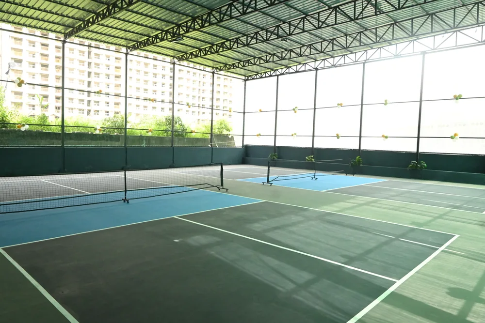 Two covered pickleball courts in daylight