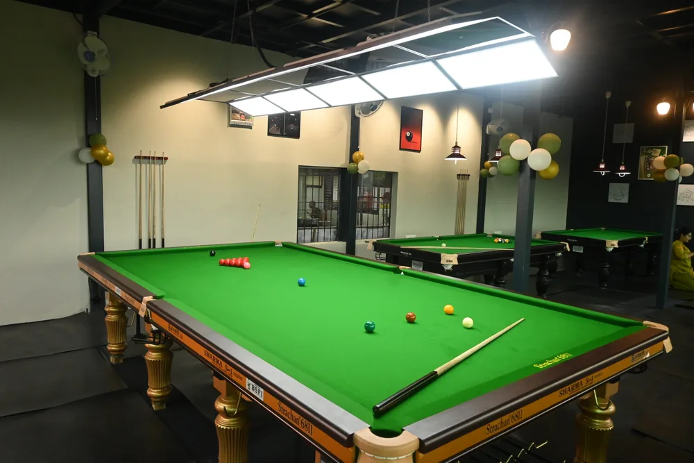 Snooker and pool tables under overhead lights